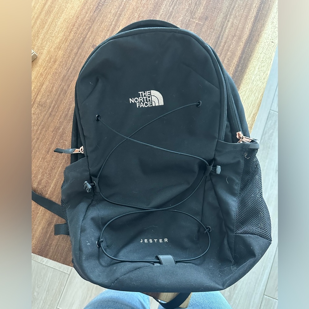 North face black and rose gold backpack